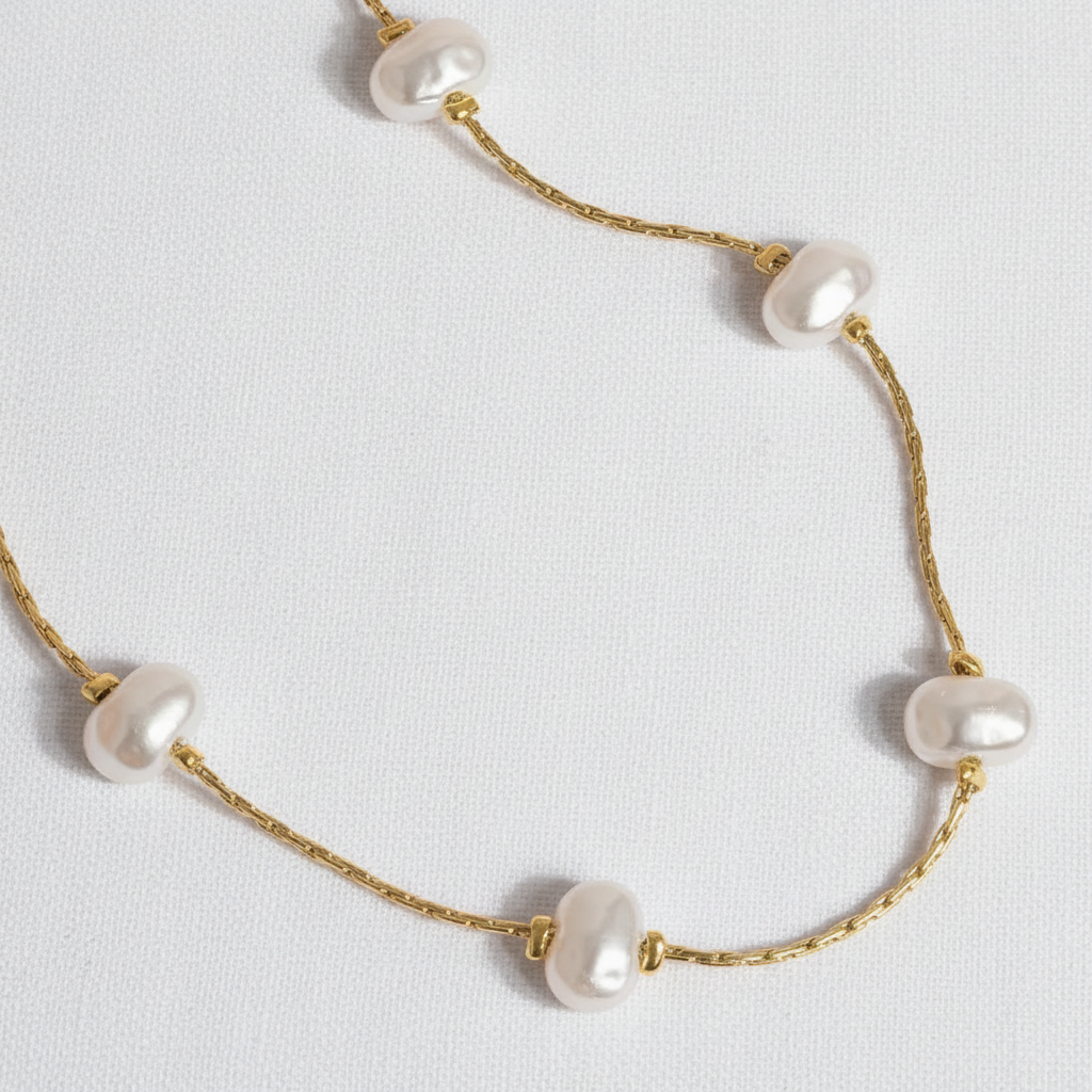 Pearl necklace on white linen